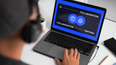 Personne travaillant sur un ordinateur portable affichant un écran bleu avec les mots «IA», «collaboration» et «partage», illustrant l’importance du travail collaboratif avec l’intelligence artificielle.